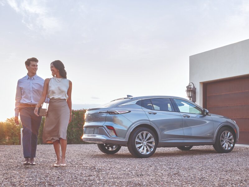 A Couple Walking Side by Side With Their Vehicle Parked in the Background