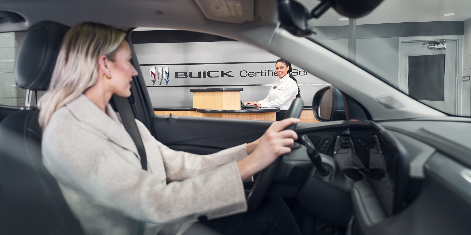 Side View of a Woman Wearing a Suit in the Driver’s Seat, Looking at the Dealer through the Window