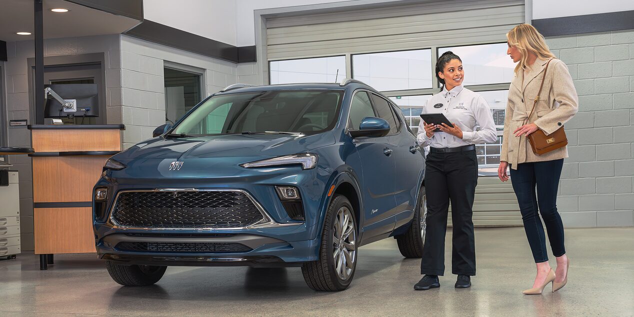 A Buick Dealers Employee Showing a Vehicle to a Customer