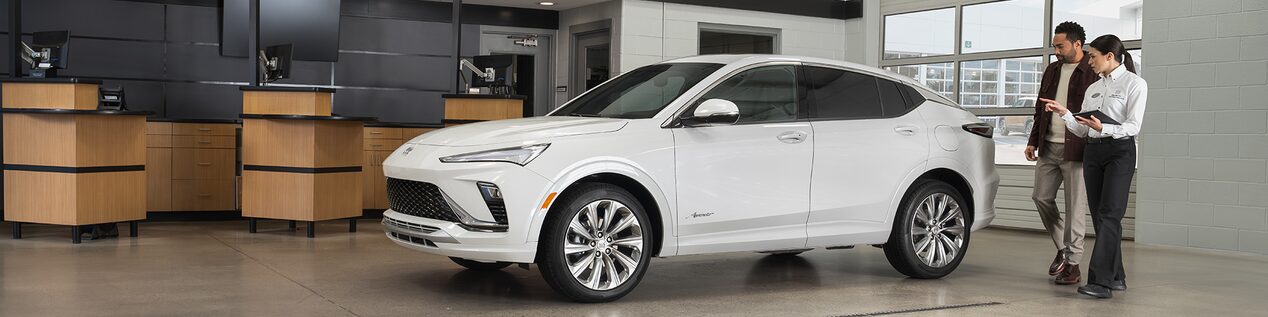 Buick Certified Service Technician Using a Tool to Work on a Vehicle