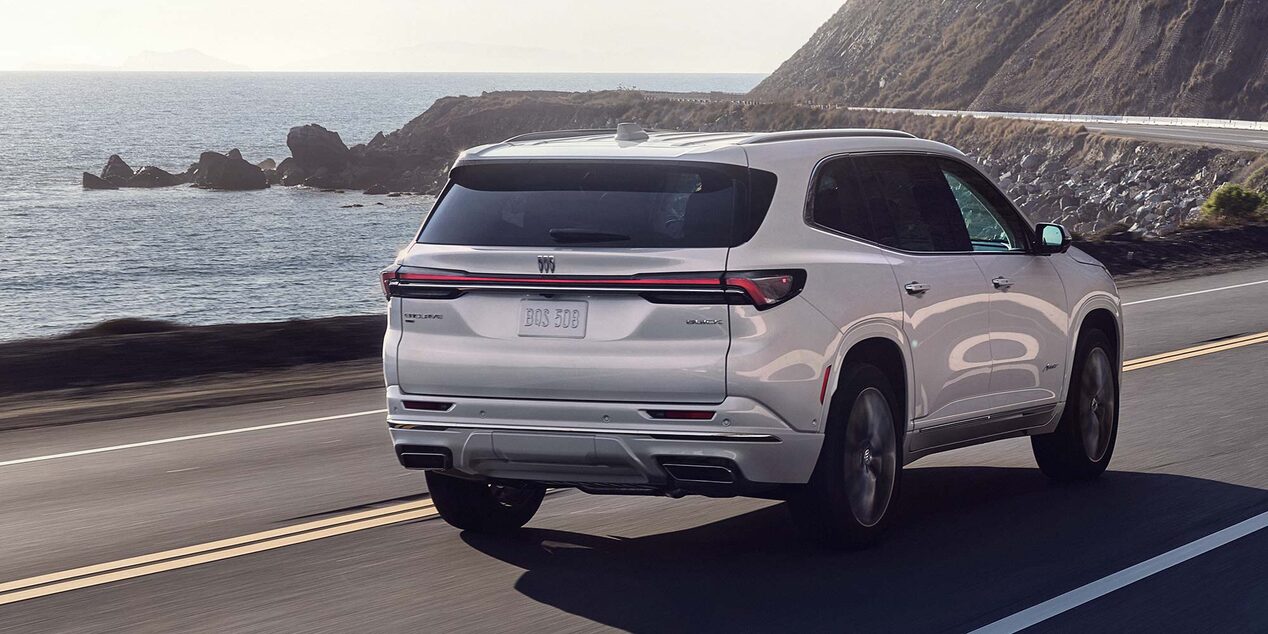 Rear View of the Buick Enclave Mid-Size SUV Driving Along the Coastline