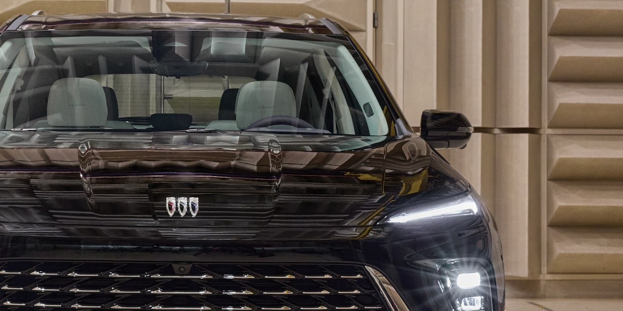 A GRAS Microphone Captures Sound Near the Grille of a Black Buick SUV in an Anechoic Chamber