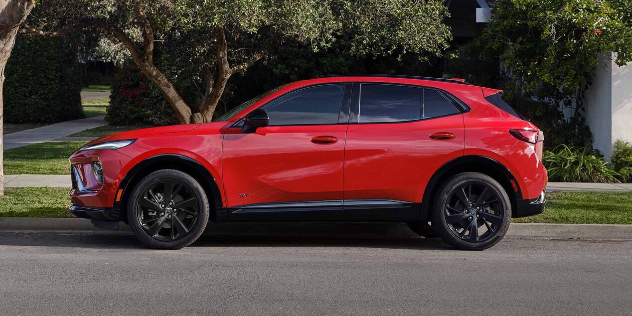 Profile View of a Red Buick SUV Parked on a Street Corner