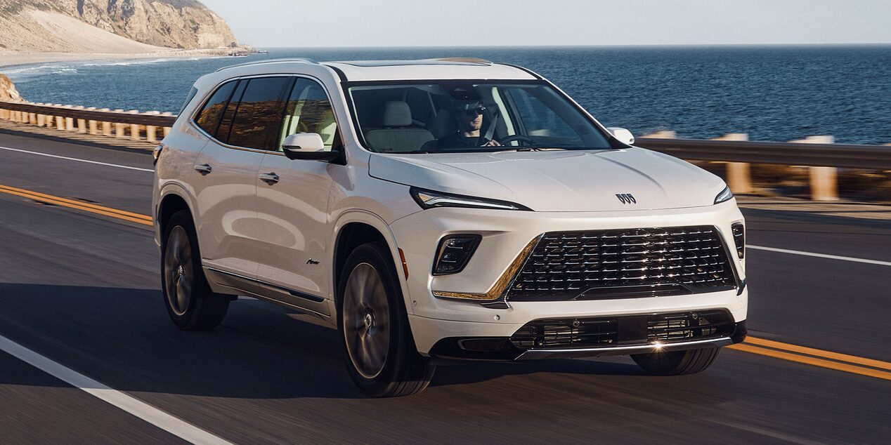 A Man Driving his Buick Vehicle up the Coast on a Sunny Day