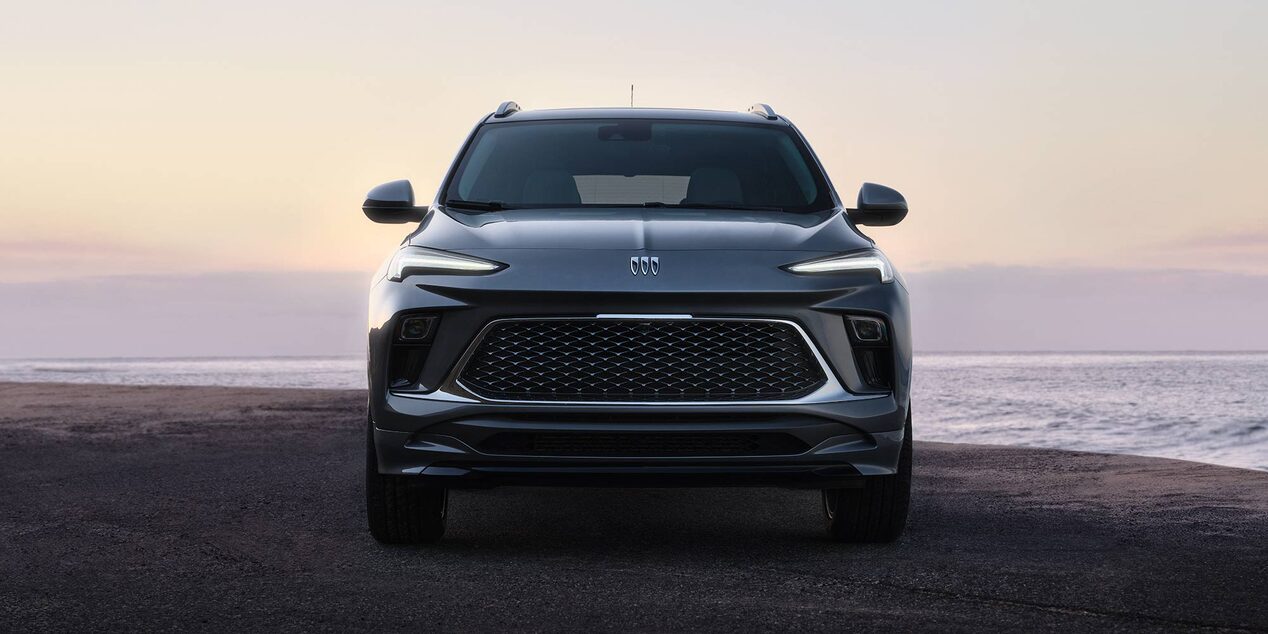Front View of the Buick Encore GX Parked on a Beach at Sunset