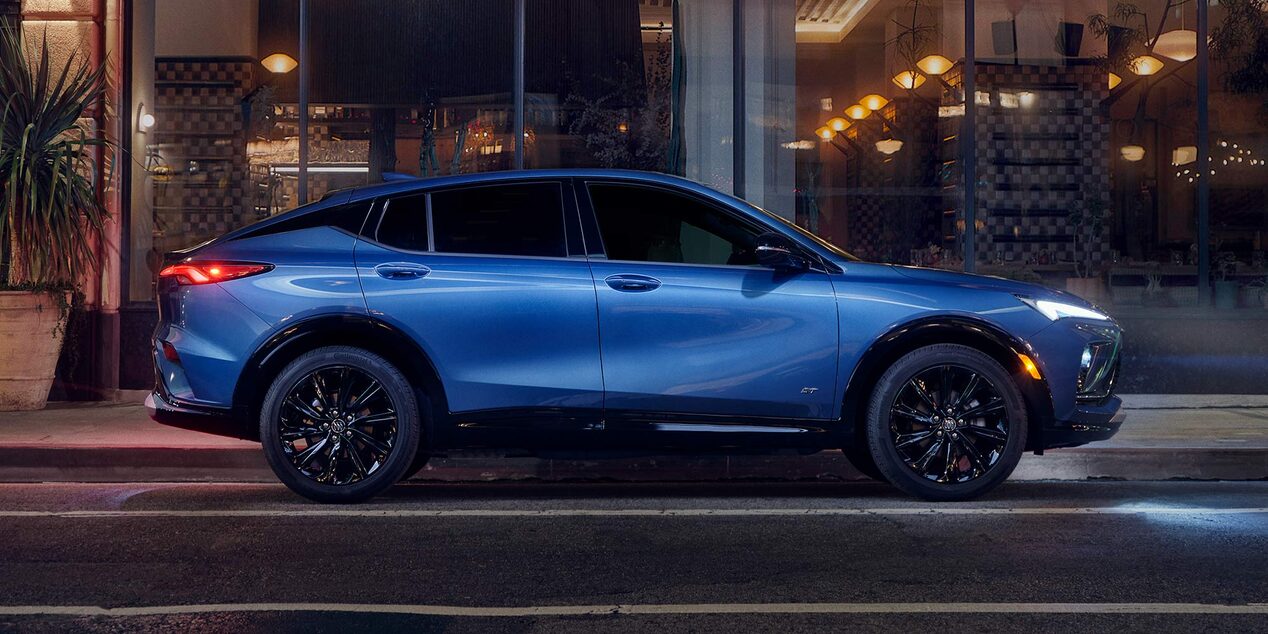 Profile View of the Buick Envista Compact SUV Parked on a City Street at Night