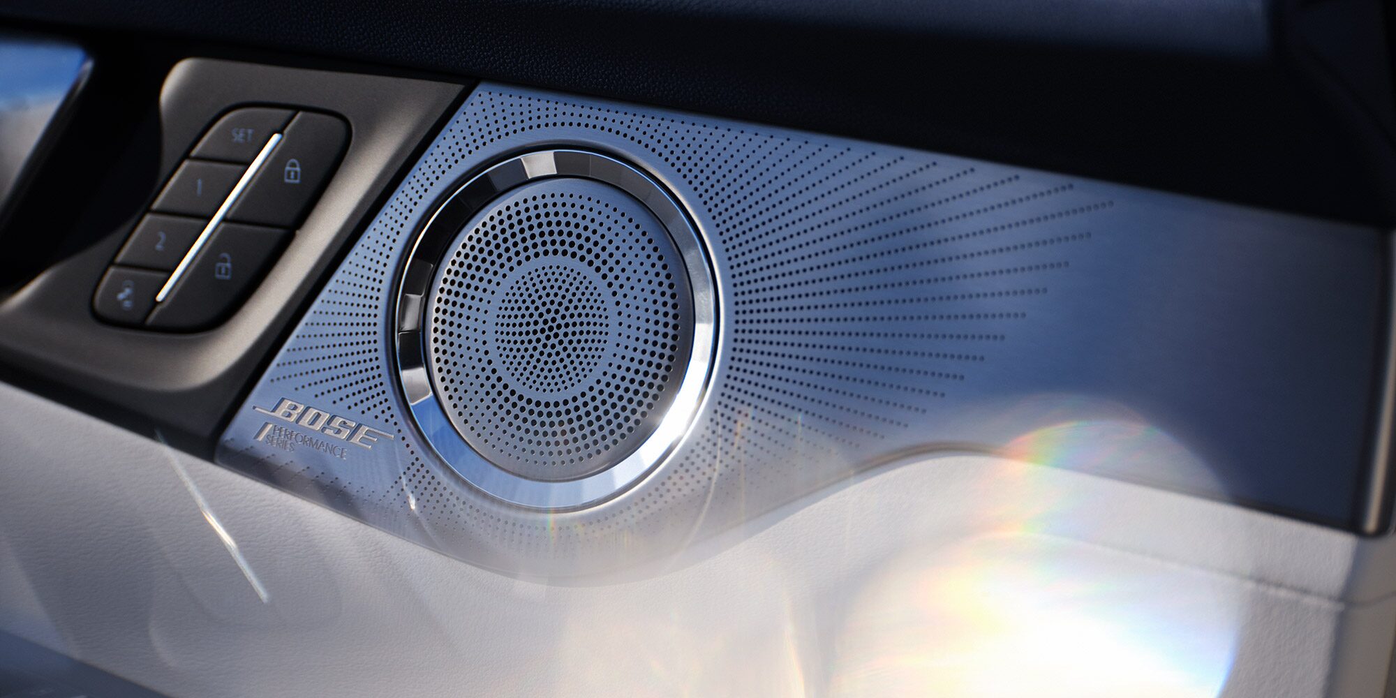 A Chrome Bose Performance Series Speaker with a Ray-Pattern Grille Located in a Buick Interior 