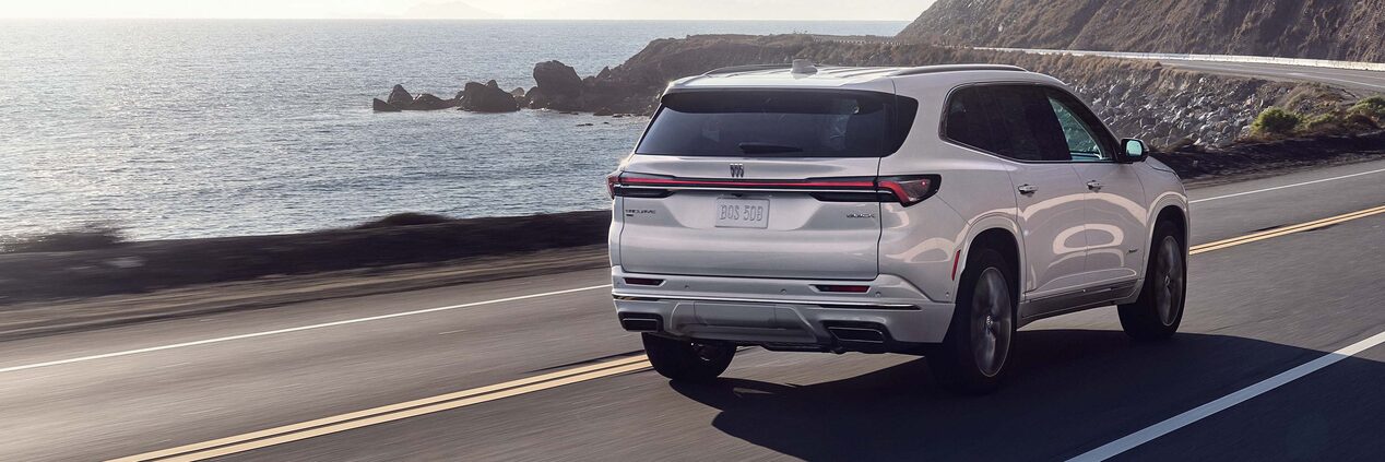 Rear View of the Buick Enclave Mid-Size SUV Driving Along the Coastline