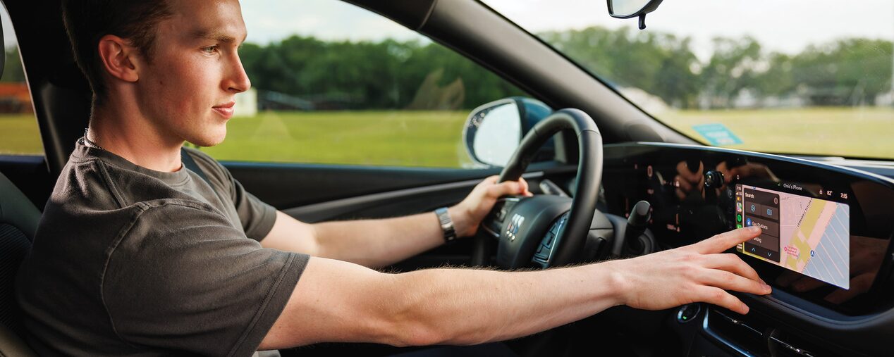 A Man Using the Infotainment System of a Buick Envista