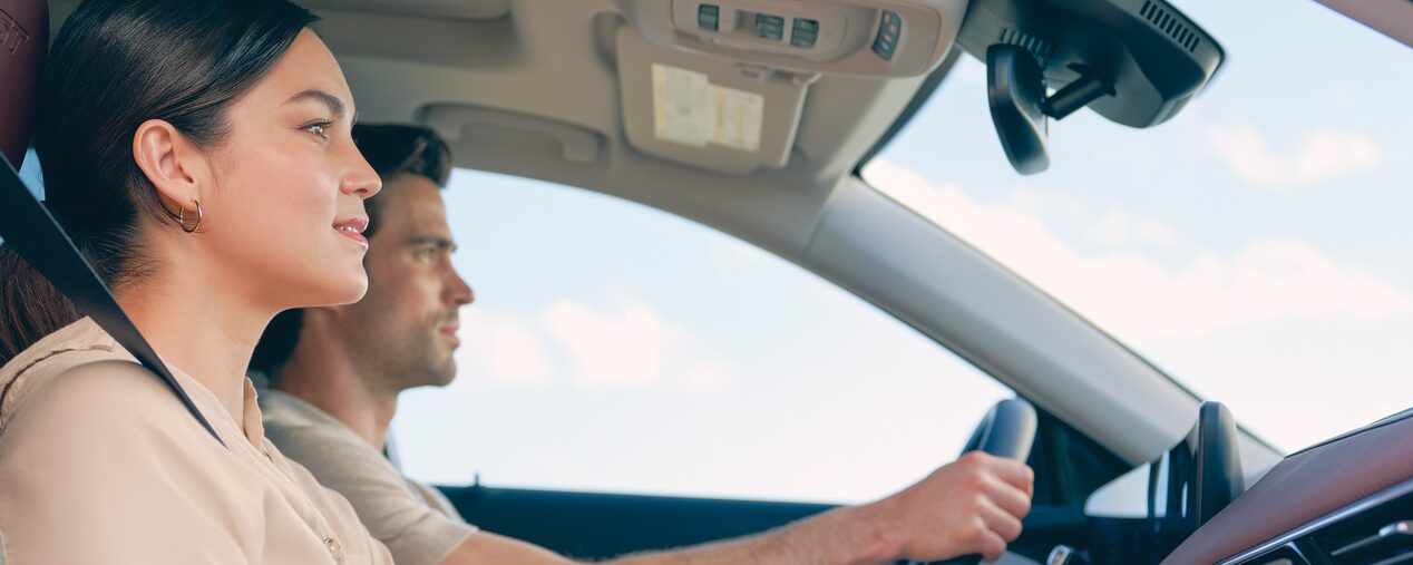 Profile View of a Man Driving and a Woman Sitting in the Passenger Seat