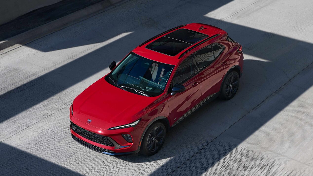 Birds-eye View of a Red Buick Enclave Mid-Size SUV Driving Down the Road