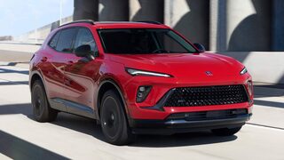 Front Three-Quarters View of a Buick Enclave Mid-Size SUV Driving Down the Highway
