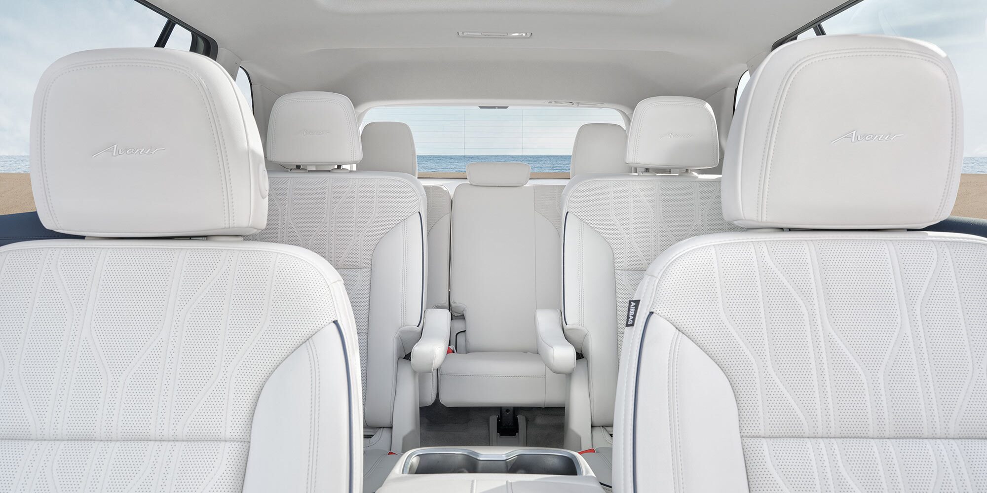 Rear View of the White Leather Avenir Interior Seats of a Buick Vehicle, Facing the Ocean Through the Back Window 