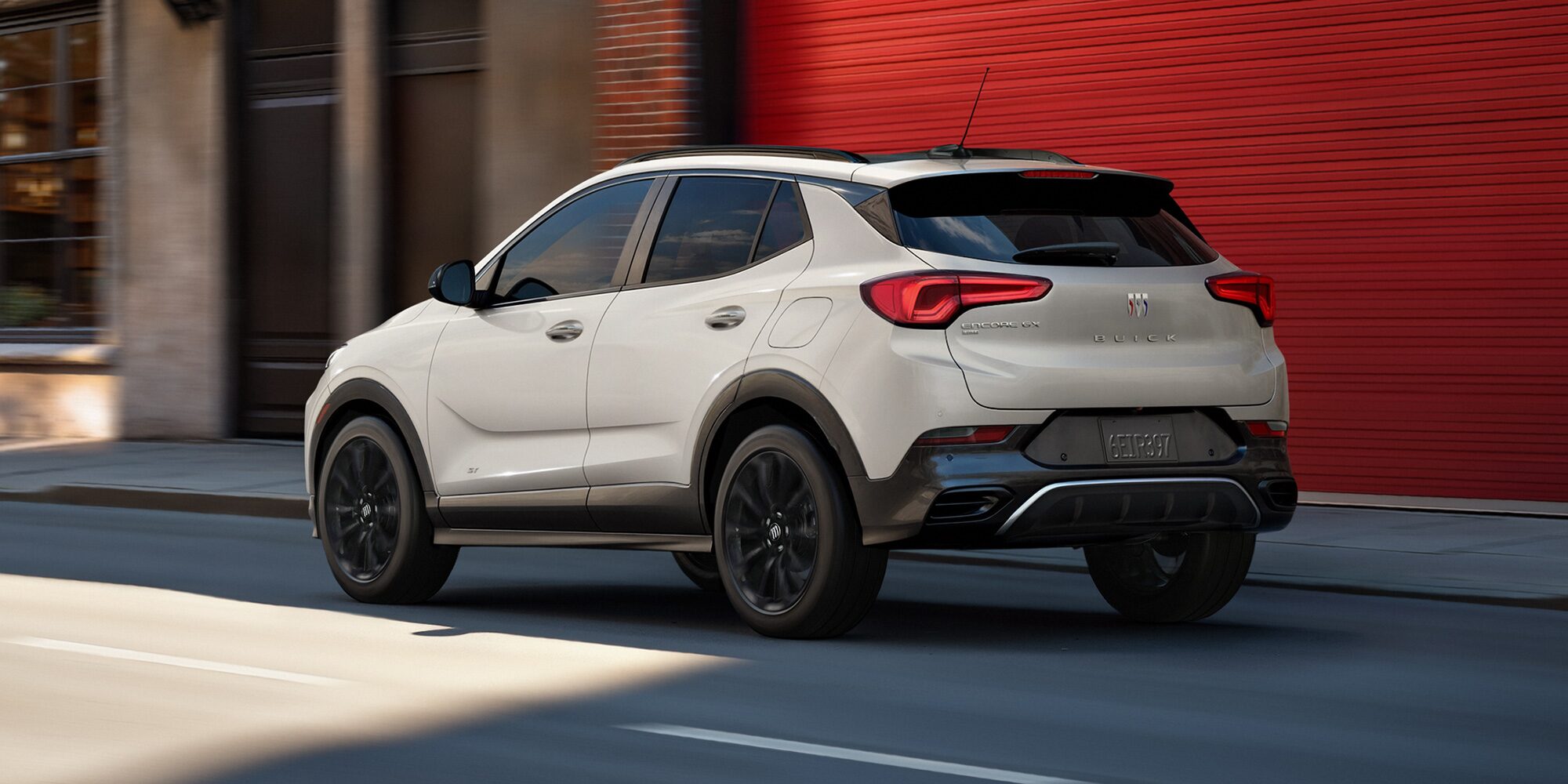 Rear View of the 2026 Buick Encore GX Sports Touring SUV Parked on a City Street