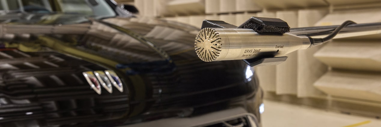 A GRAS Microphone Captures Sound Near the Grille of a Black Buick SUV in an Anechoic Chamber