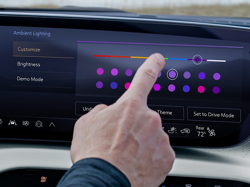 Close-up of the Driver Using the Buick Infotainment Screen to Adjust the Cabin Lighting
