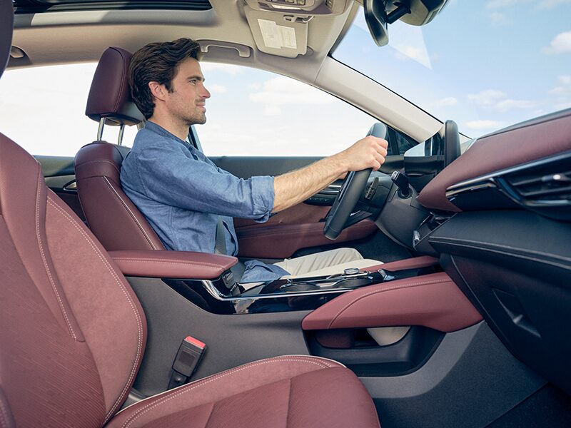 Passenger Side View of a Man Driving His Buick Envision