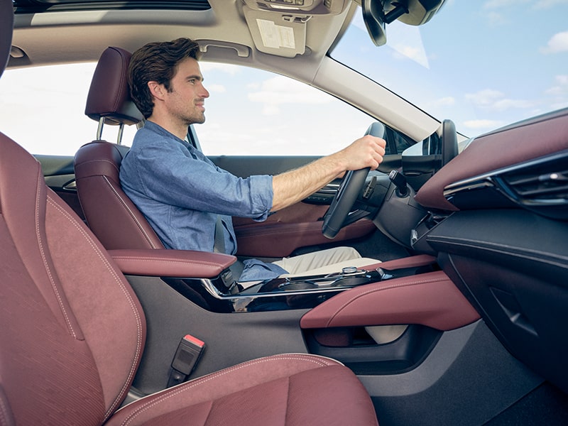 Passenger Side View of a Man Driving His Buick Envision
