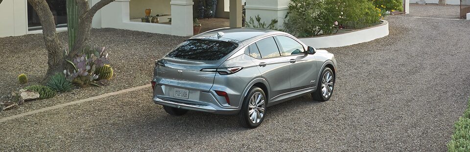 Grey buick suv parked on gravel road