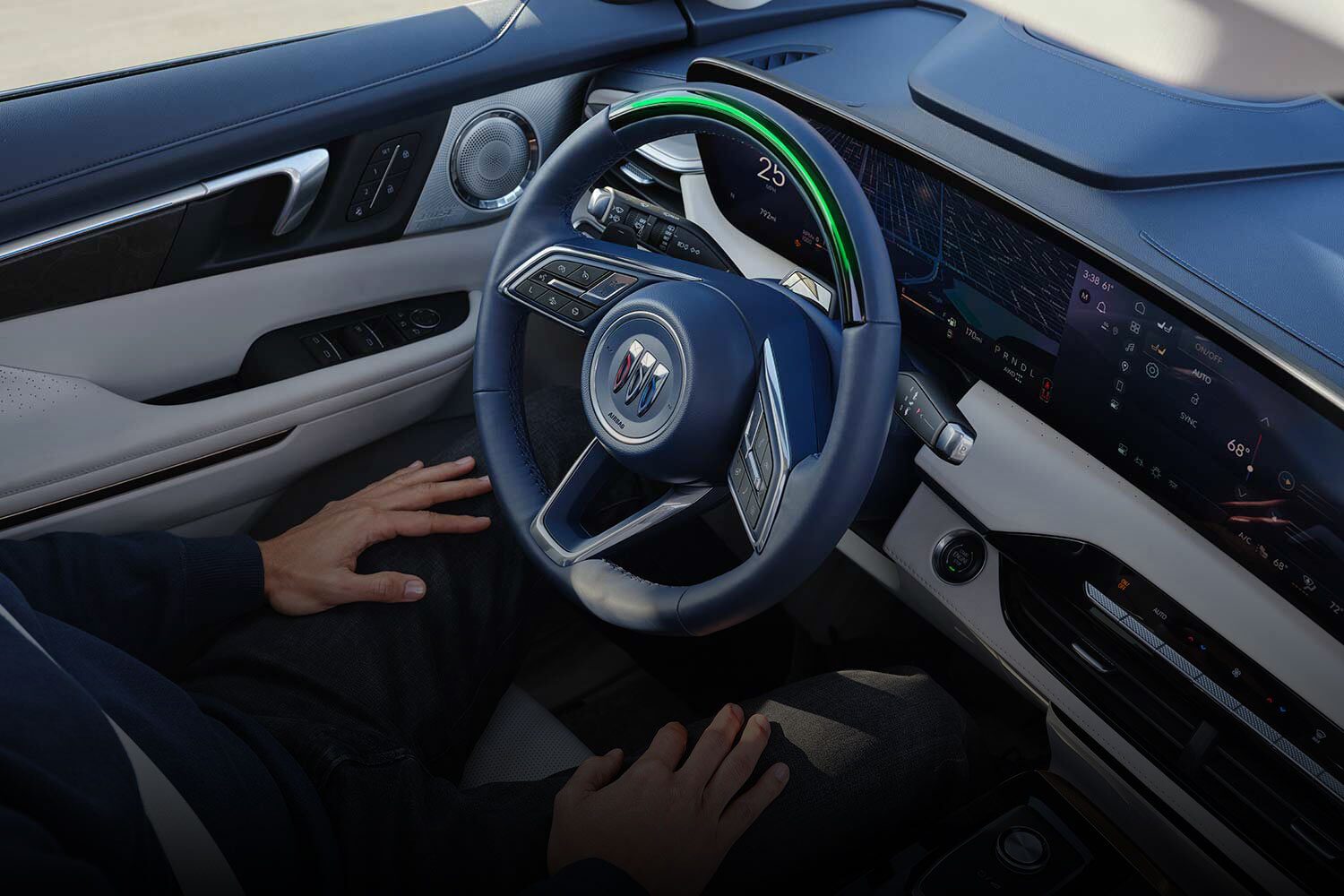 A Driver's Hands Beside the Steering Wheel of a Buick Avenir with Digital Displays