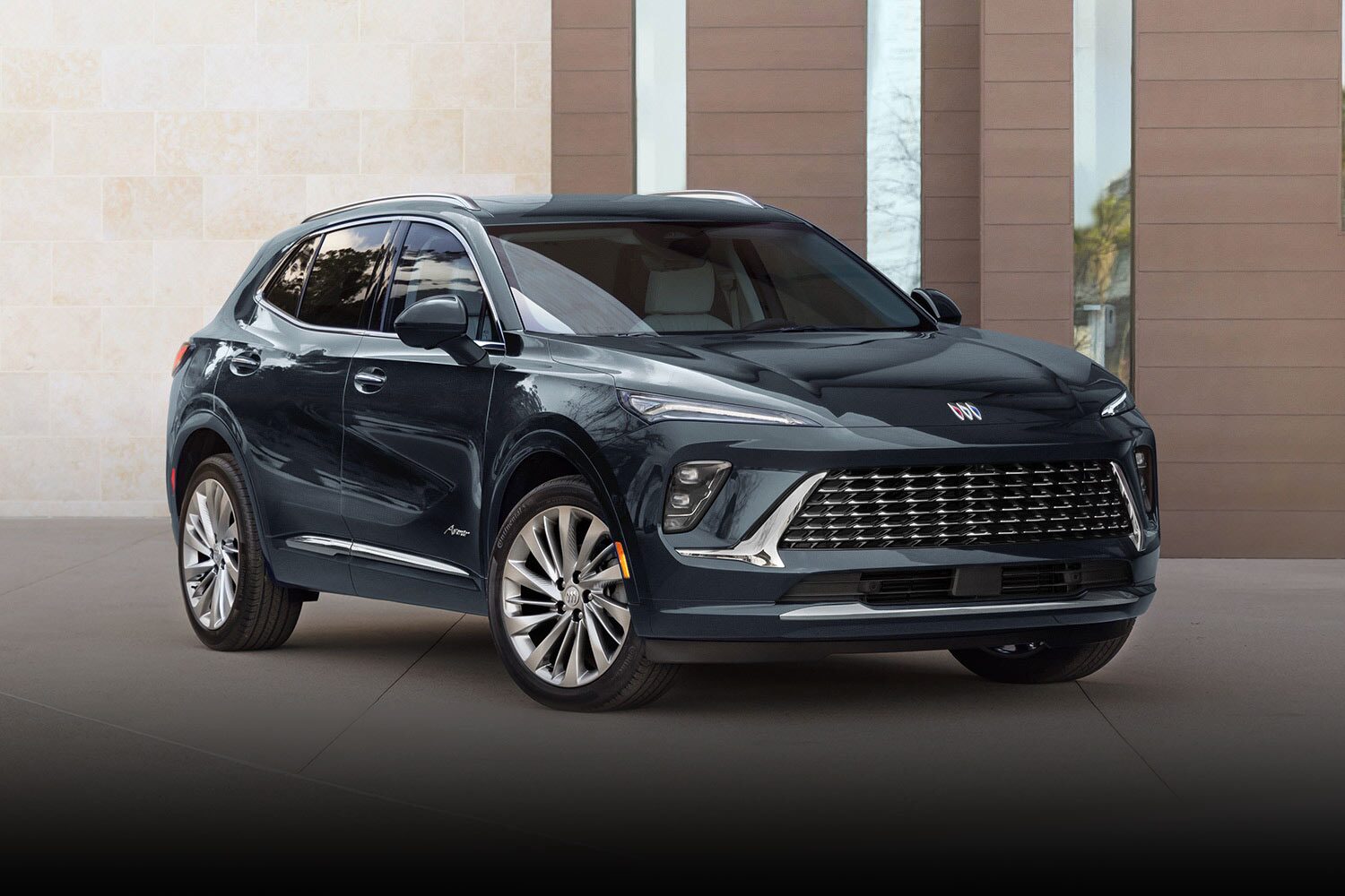 A Dark Blue Buick Envision Avenir SUV Parked in Front of a Modern Building