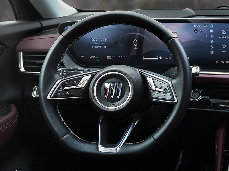 Close-up View of the Steering Wheel and Digital Dashboard in a 2025 Buick Envision ST Sporty SUV