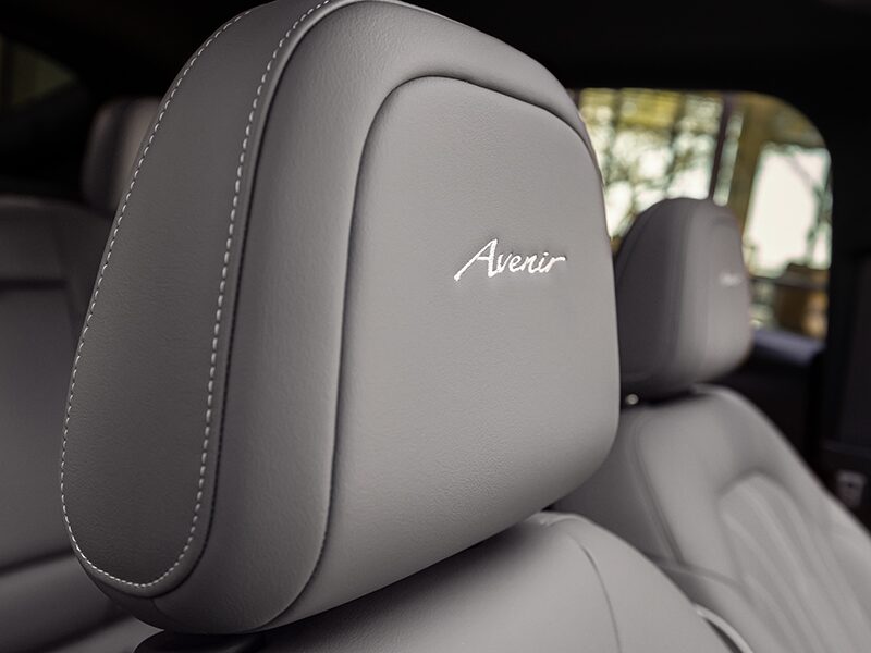 Close-up View of the 2025 Buick Envista Avenir Nameplate Embroidered on the Front Seat Headrest