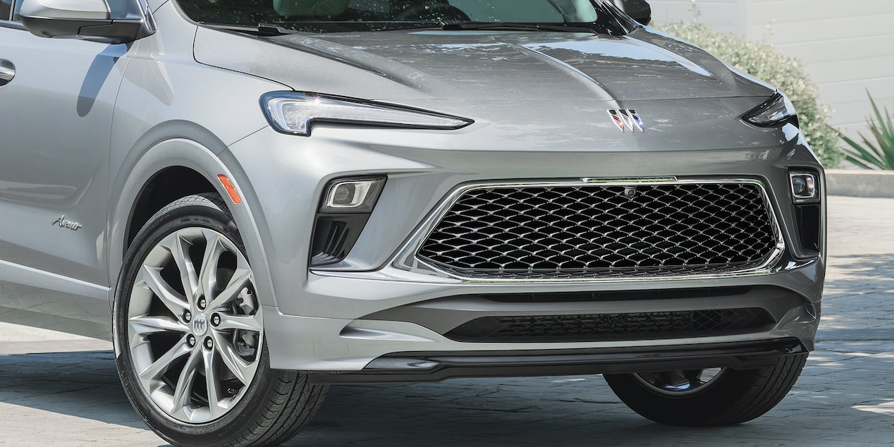 Front-side view of the 2025 Buick Encore GX Avenir parked on a pavement.