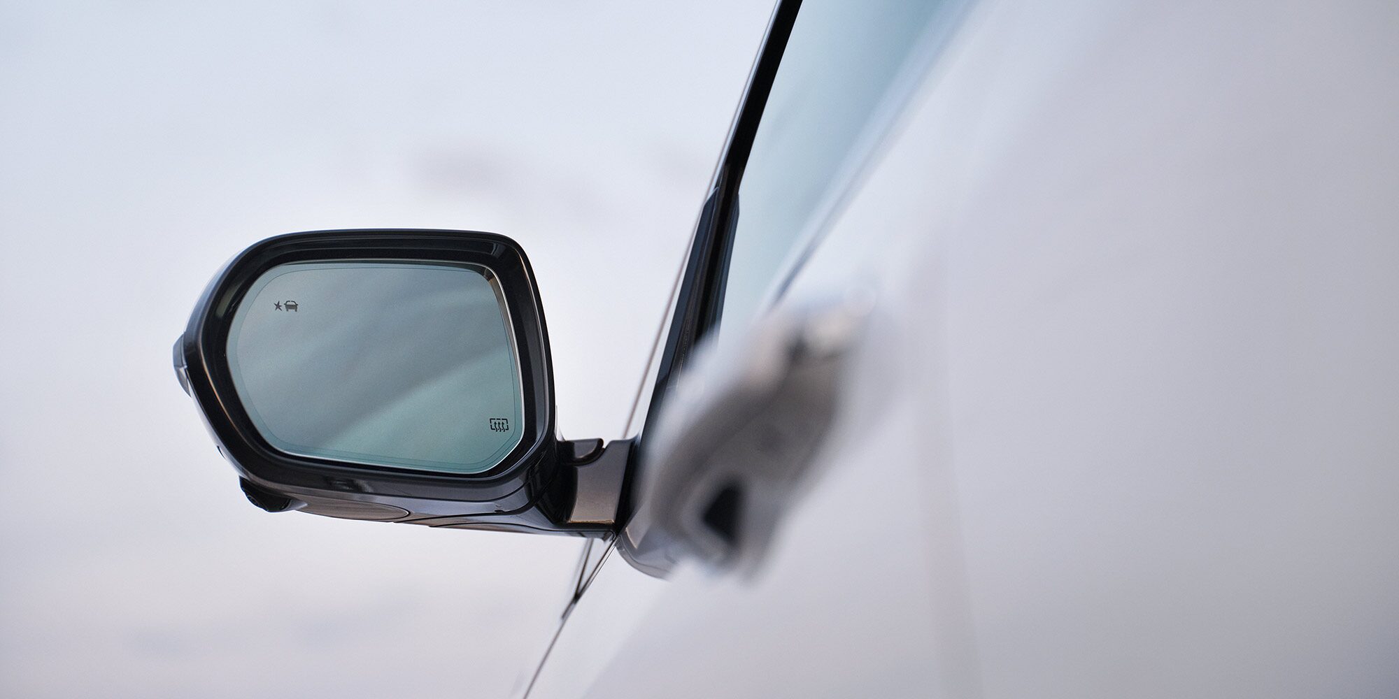 Three-Quarters View of a 2026 White Buick Enclave Under a Sunset Sky