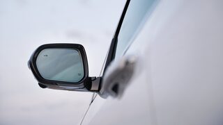 Three-Quarters View of a 2026 White Buick Enclave Under a Sunset Sky