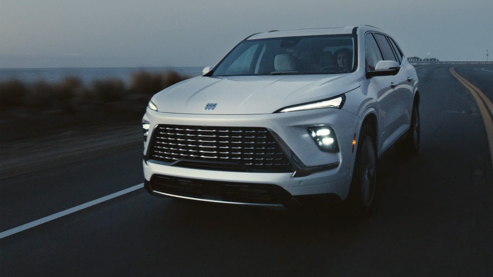 Close-up of a 2026 White Buick Enclave Front Hood with a Focus on the Front Headlight