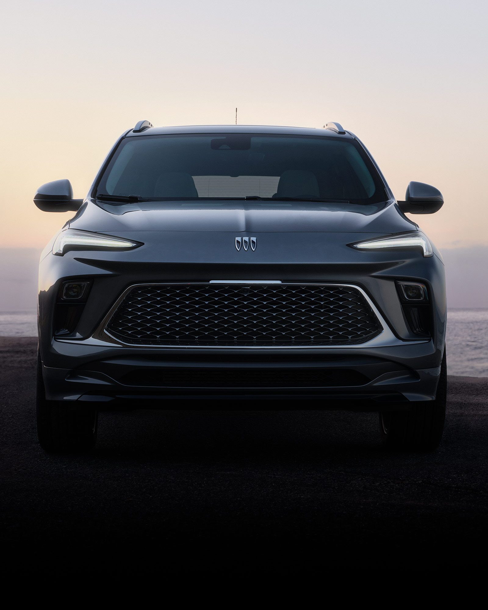 Close-up of the Front View of the Buick 2026 Encore GX Preferred Subcompact SUV Parked on the Beach at Sunset