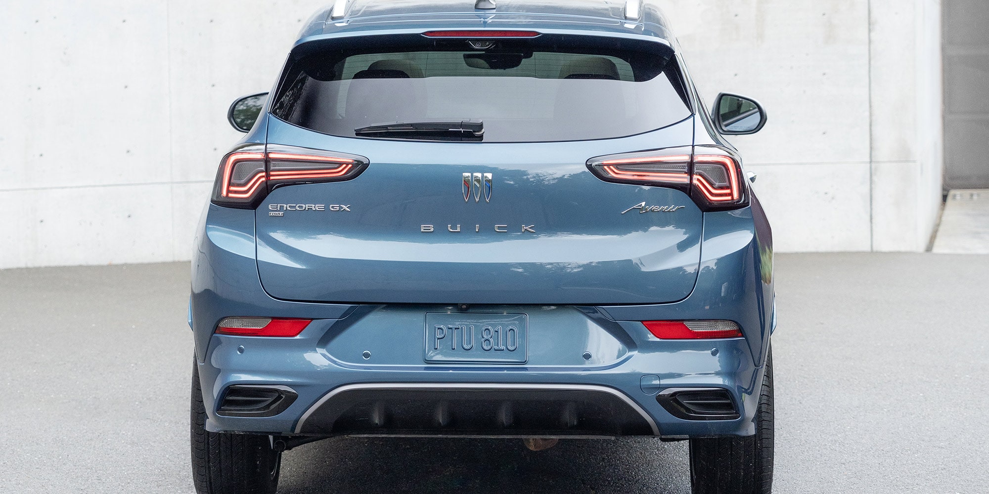 Rear view of the 2026 Buick Encore GX parked in a driveway.