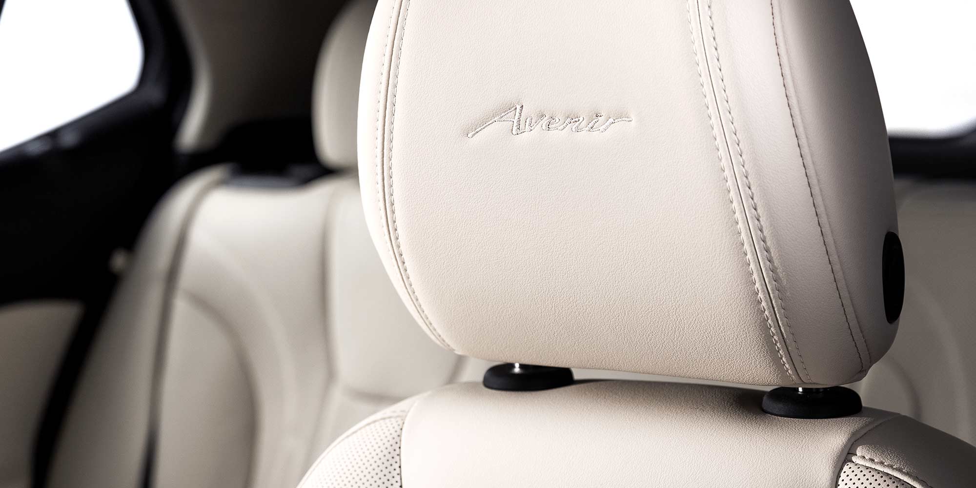 Close up view of the Avenir badging on the headrest of the 2026 Encore GX Avenir.