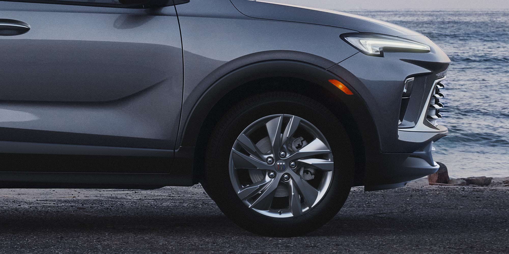 Side view of the 2026 Buick Encore GX Preferred parked by the beach.