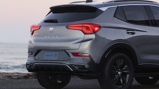 Back-side view of the 2026 Encore GX ST parked alone by the beach.