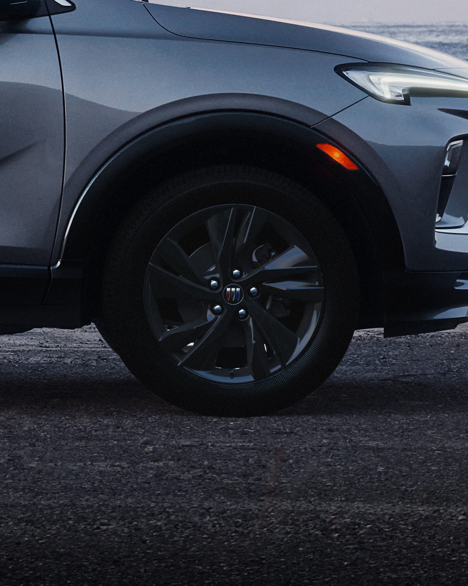 Exterior Profile View of the Buick 2026 Encore GX ST Sporty SUV Parked on a Beach