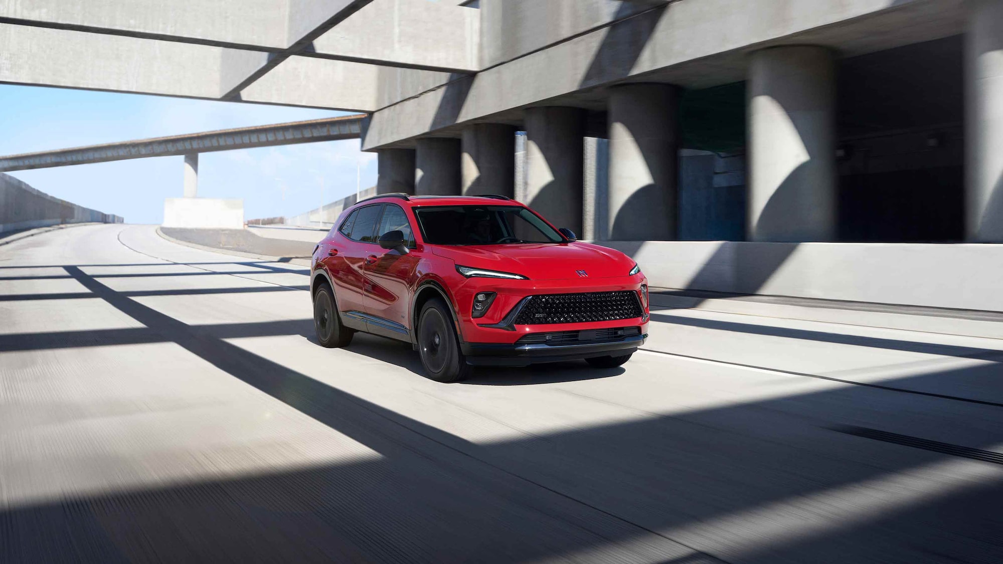 Front Three-Quarters View of the 2026 Buick Envision Compact SUV Driving Down the Freeway