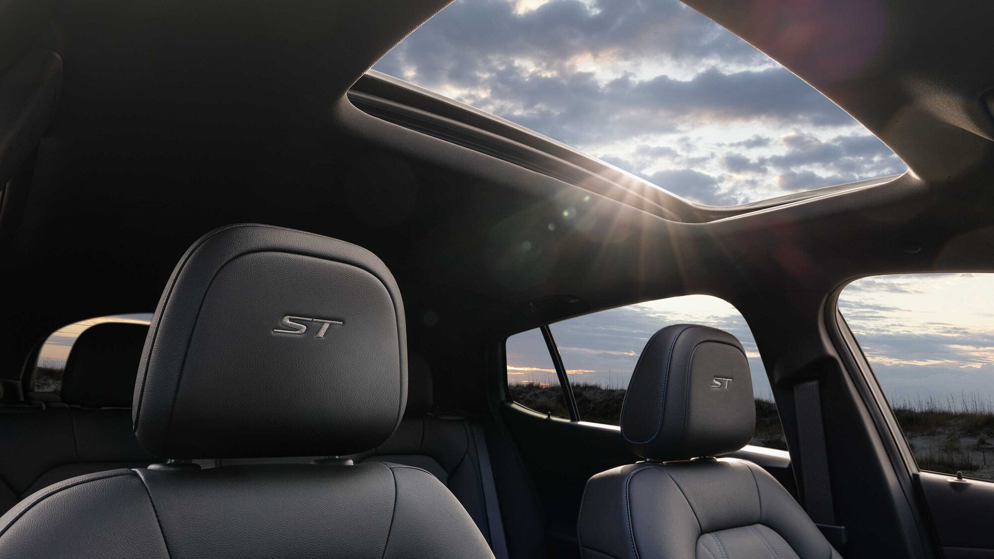 The 2026 Buick Envista Front Row Seat Head Restraints while the Sun Shines Through the Moonroof