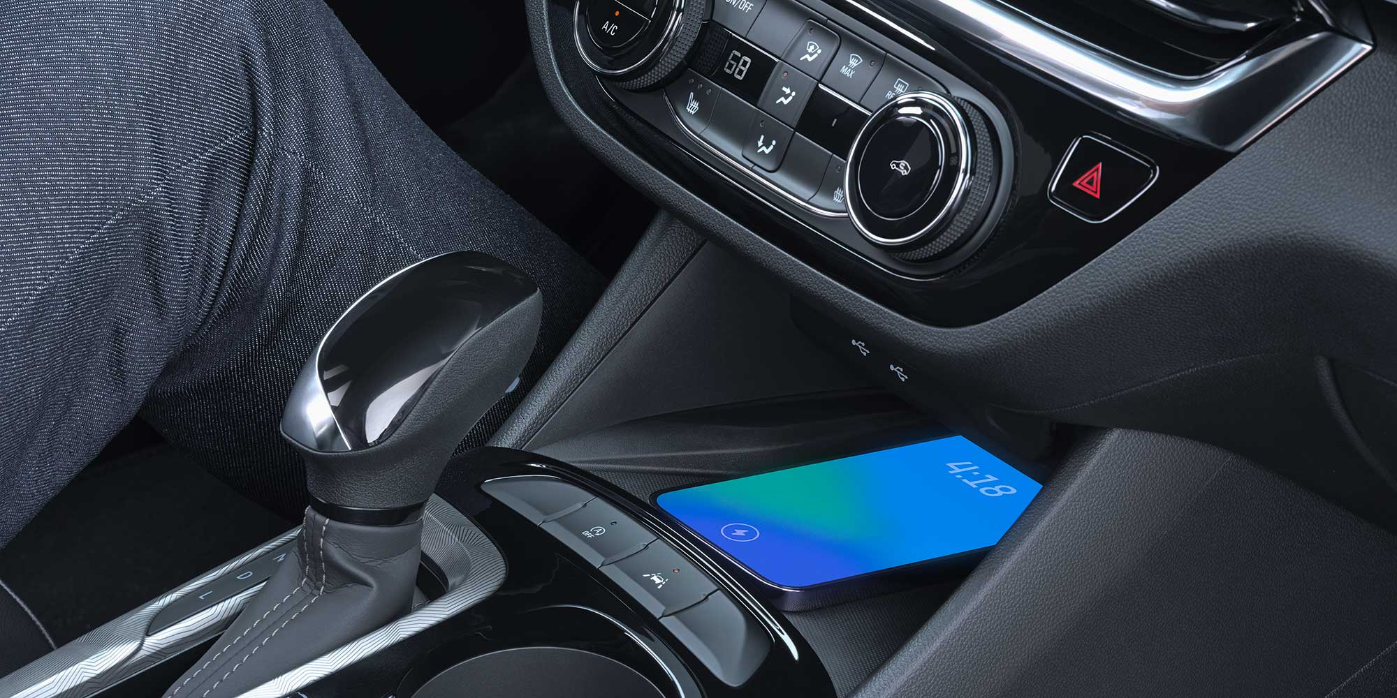 Close-up Interior View of a Smartphone Charging on the Wireless Charger in the 2026 Buick Envista
