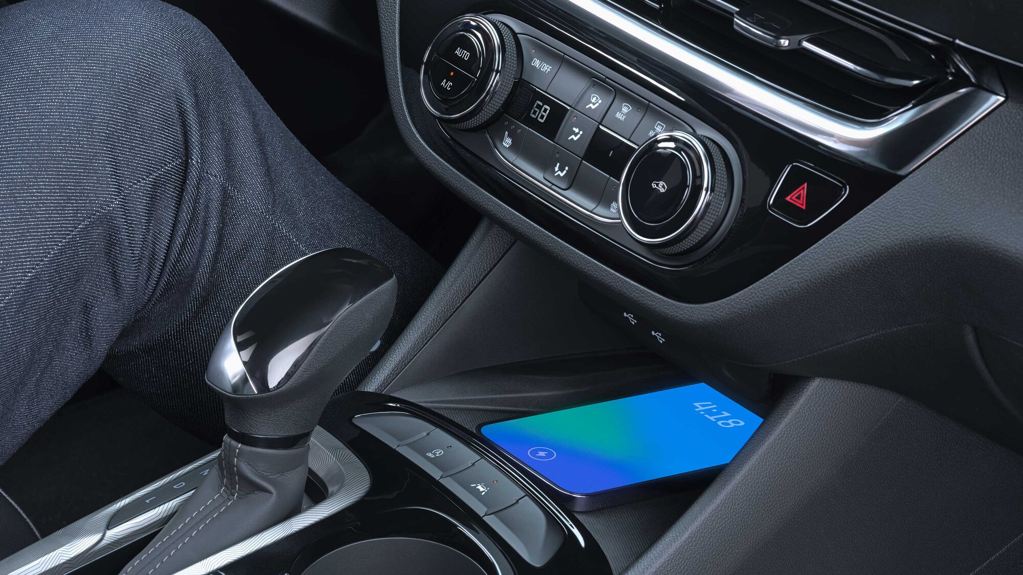 Close-up Interior View of a Smartphone Charging on the Wireless Charger in the 2026 Buick Envista