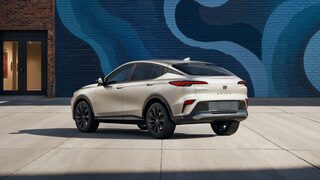 Rear View of the 2026 Buick Envista ST SUV with the Studio Series Package Parked Next to a City Building Covered with a Colorful Abstract Mural