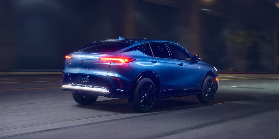 Blurry Rear Passenger View of the 2026 Buick Envista Driving Down the Road at Night