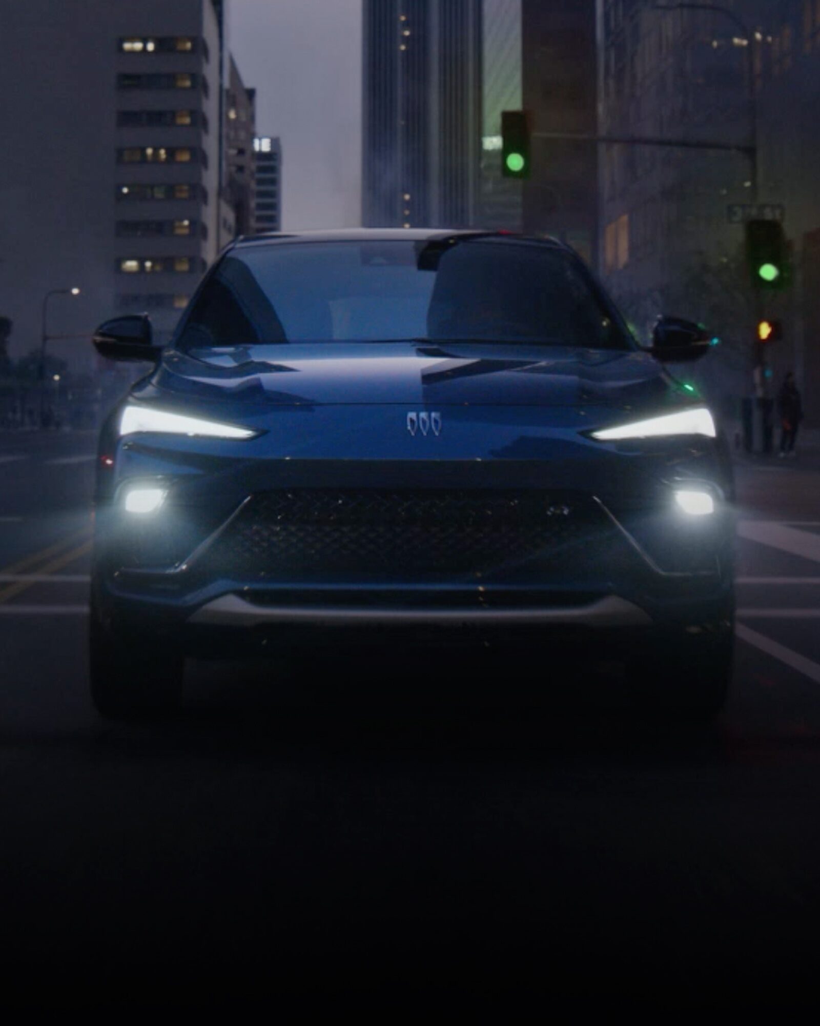 The 2026 Buick Envista Compact Crossover Driving Through the City in Downtown