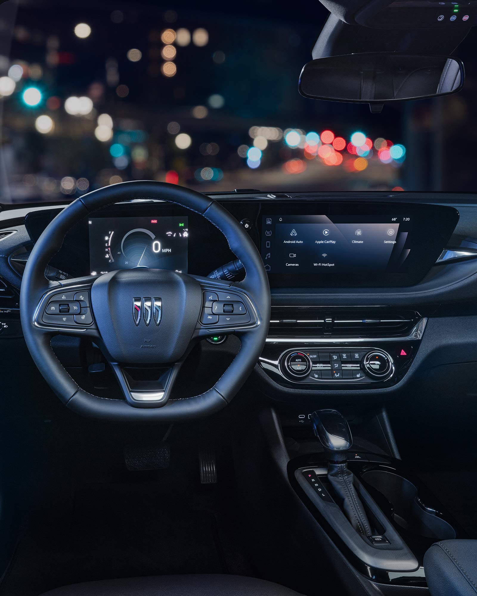 Blurry View of the 2026 Buick Envista Front Row Interior and Dashboard Outlooking the City at Night